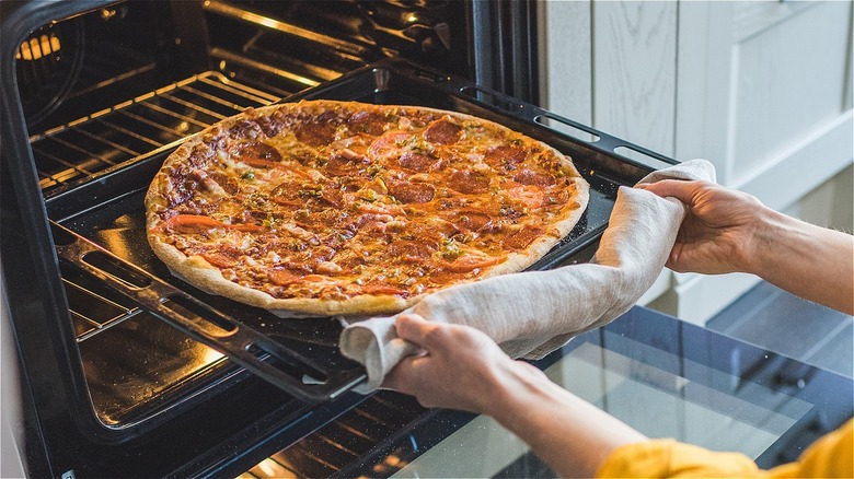 Pizza entering an oven