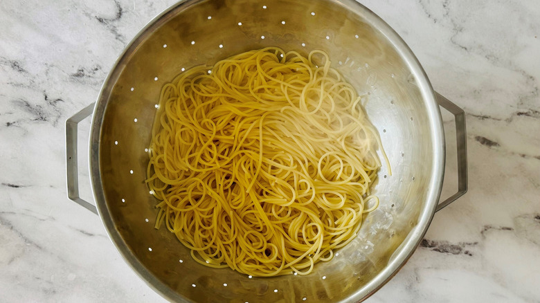 cooked noodles in a colander