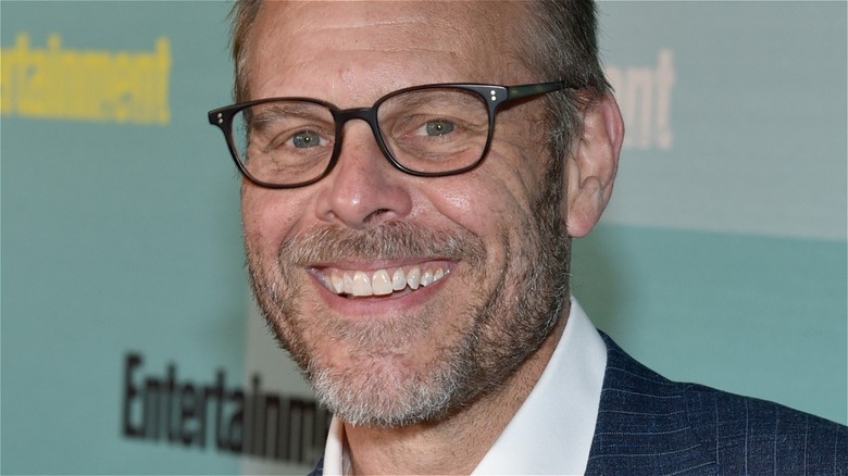 Smiling Alton Brown wearing glasses 