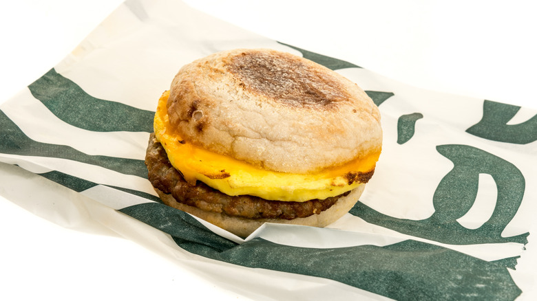 Starbucks sausage, egg, and cheddar placed on top of white bag with logo