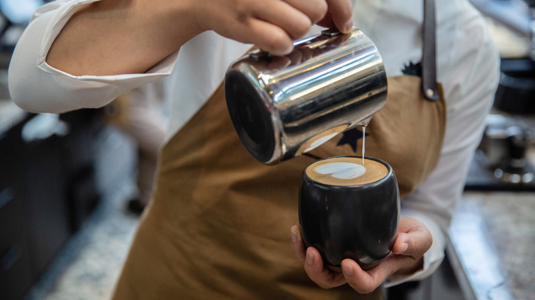 Barista pouring latte art