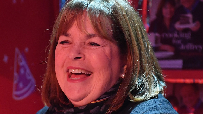 Ina Garten laughing with red background