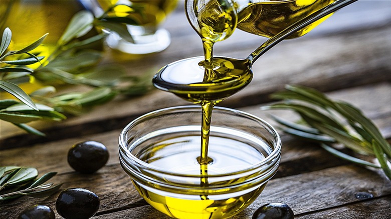 olive oil poured on spoon