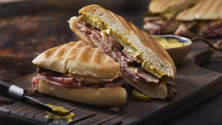 Classic Cuban sandwich with pork, Swiss cheese, mustard, and pickles