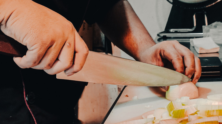Chef cutting onions