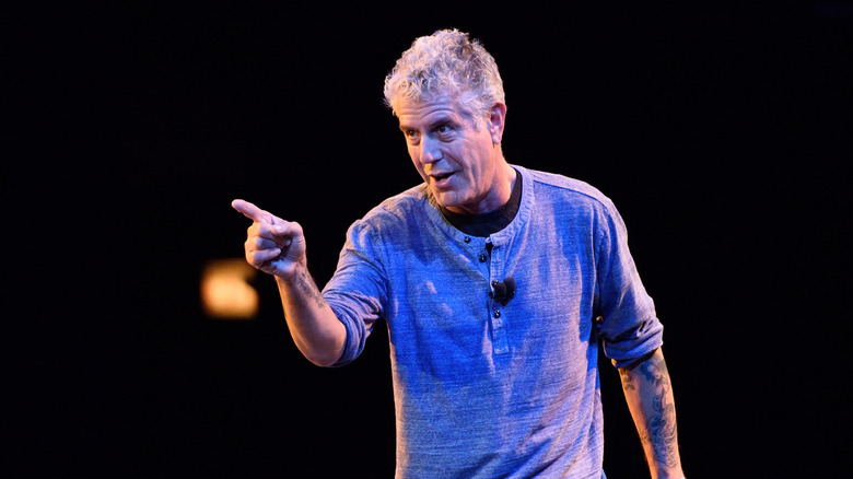 Anthony Bourdain pointing on stage