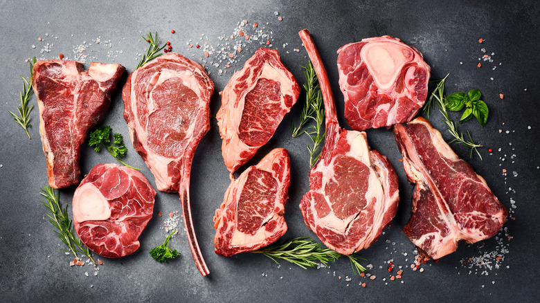 Variety of bone-in steaks on a slate