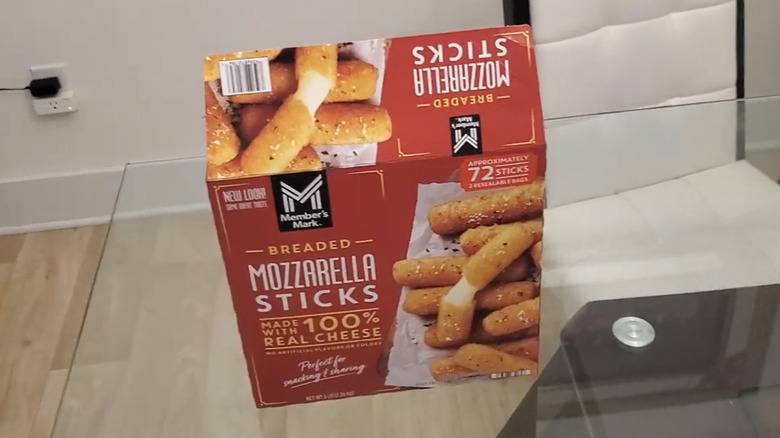 An opened box of Member's Mark Mozzarella Sticks on top of a glass table
