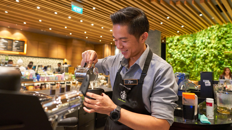 Starbucks employee making a drink