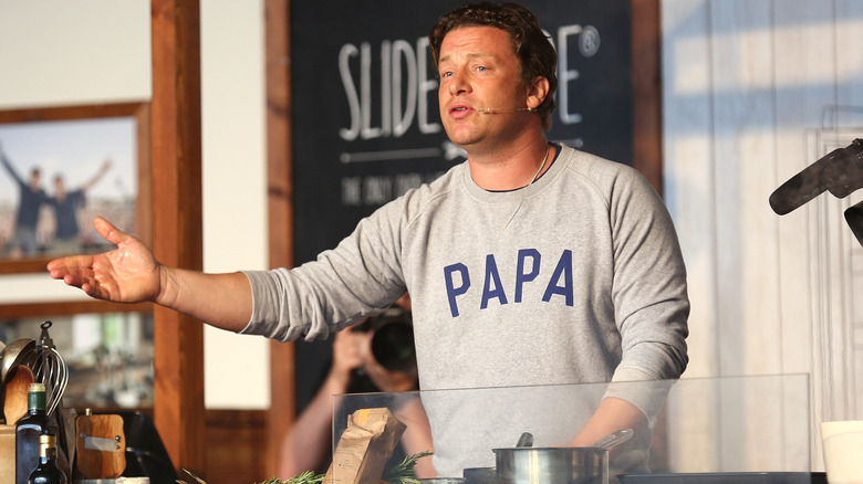 Jamie Oliver cooking for an audience