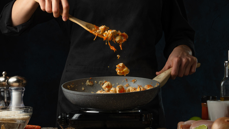 Chef tossing food in a pan