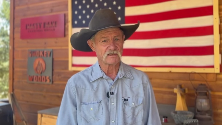 Cowboy Kent Rollins in a YouTube video with the US flag framed behind him