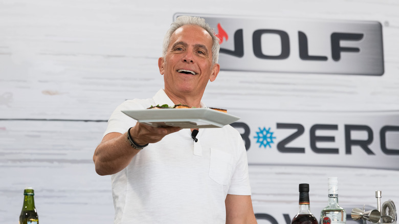 Chef Geoffrey Zakarian holding a plate of food