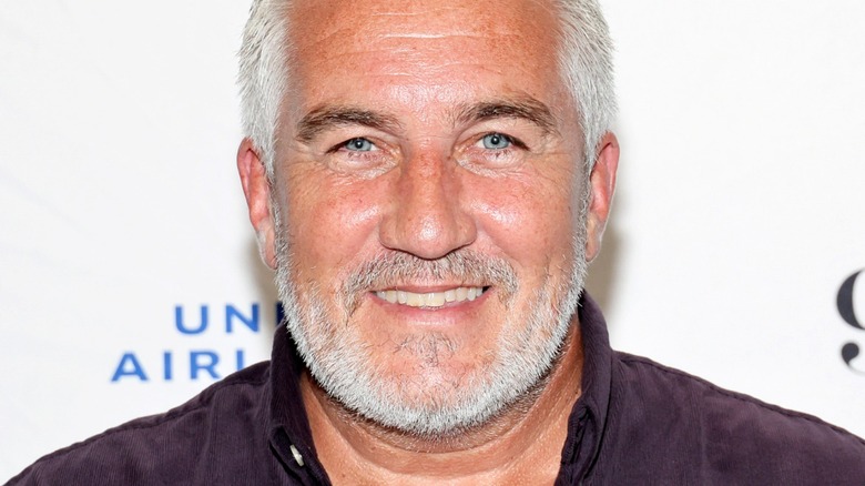 Paul Hollywood smiling in black shirt