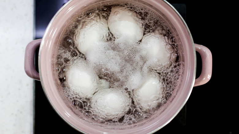 Eggs boiling in pot from above