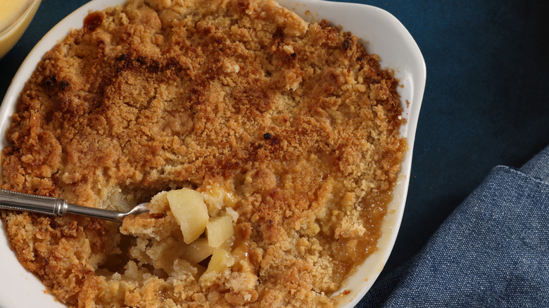 An apple crumble in ceramic baking dish