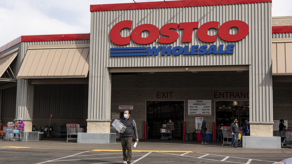 Man walking in front of Costco building