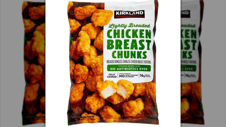 Bag of Kirkland Signature lightly-breaded chicken breast chunks against white background.