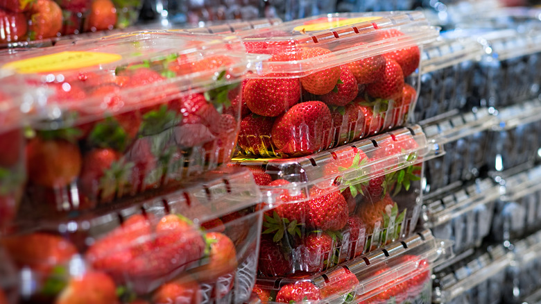 Punnets of supermarket strawberries and blueberries