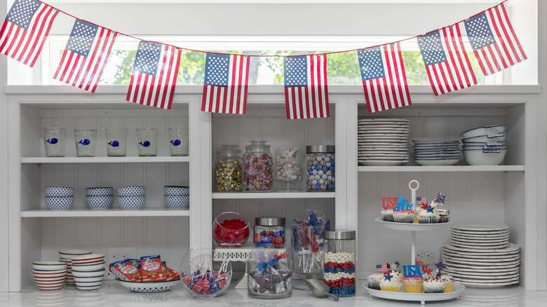 Counter display with patriotic desserts and an American flag banner