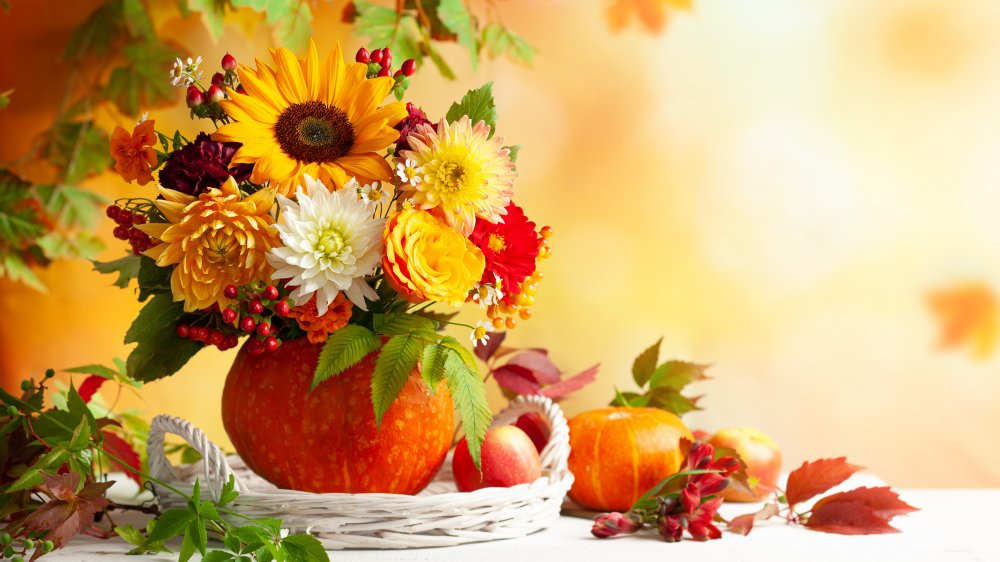 fall flower arrangement inside a pumpkin