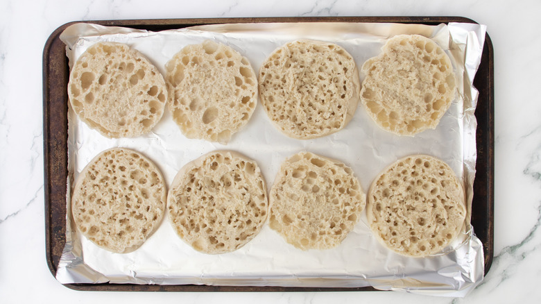 english muffin halves on baking sheet