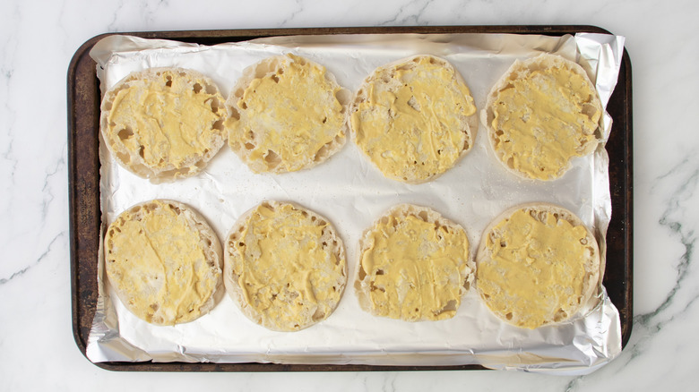 english muffin halves with butter and mustard