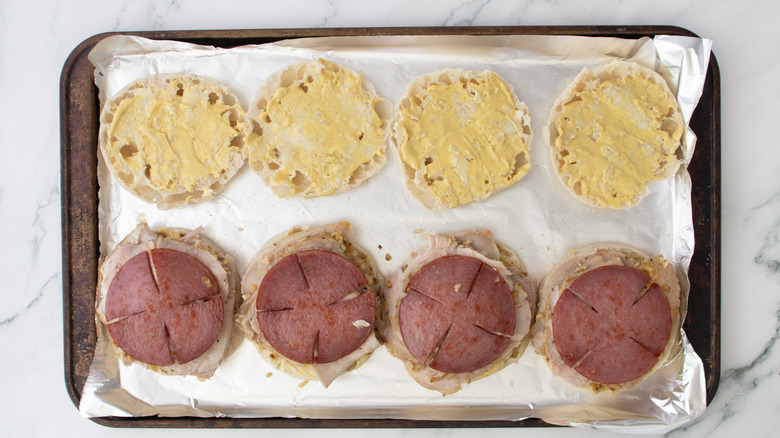 english muffin halves topped with pork
