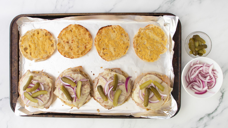 cuban-style breakfast sandwich halves garnished with onions and pickles