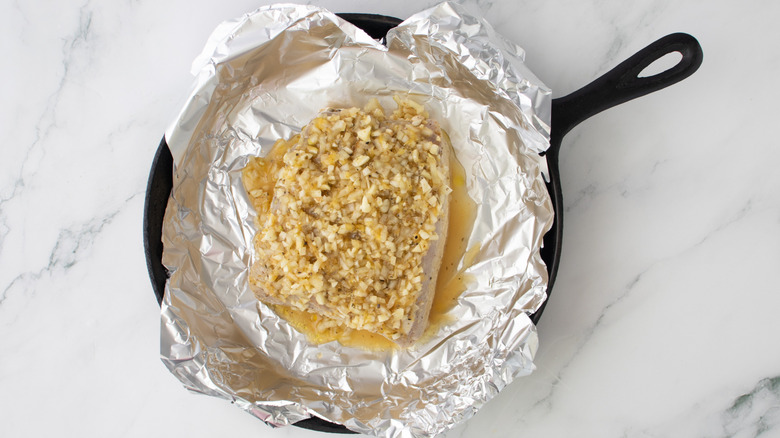 marinated pork loin in tin-foil-lined skillet