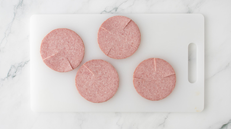 sliced pork roll on cutting board