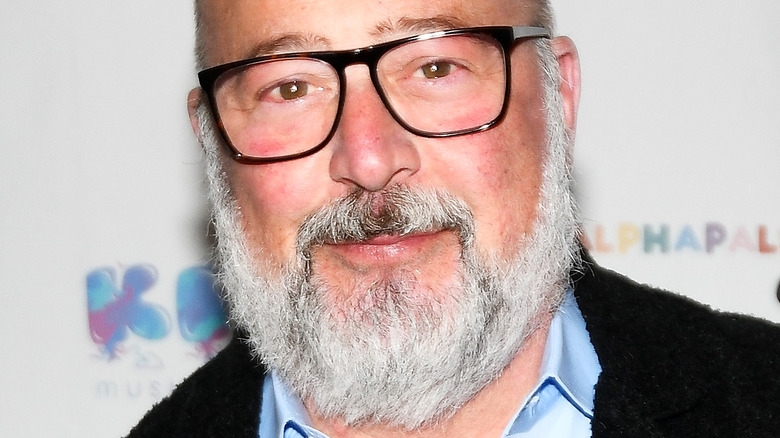 Andrew Zimmern in black glasses