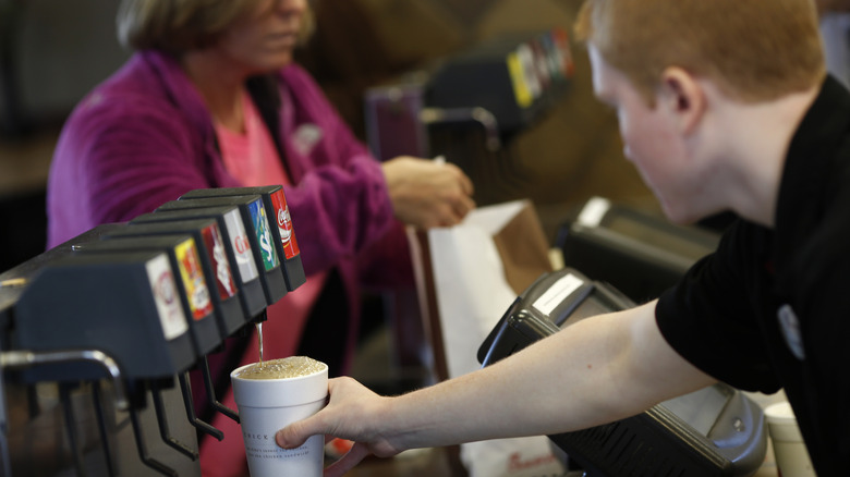 Chick-fil-A employee and customer at soda machine