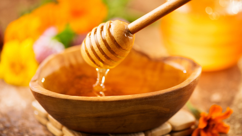 Honey dripping into a bowl