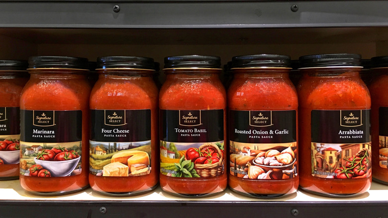 Jars of Signature Select tomato sauce on store shelf