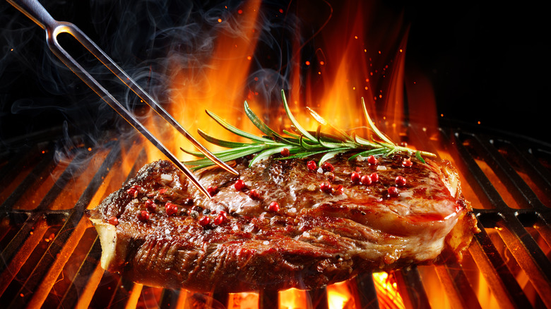 Steak on hot charcoal grill