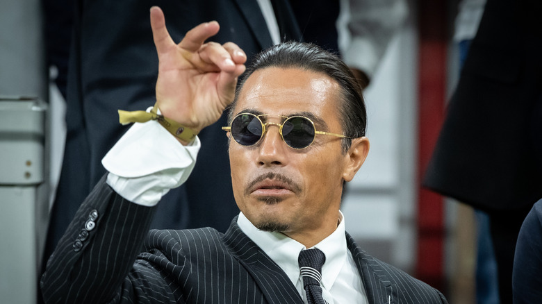 Salt Bae making his signature sprinkling gesture