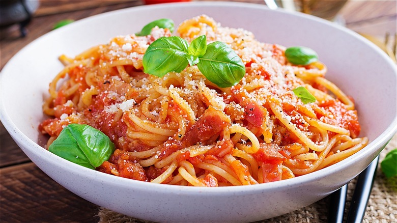 Bowl of spaghetti sprinkled with cheese