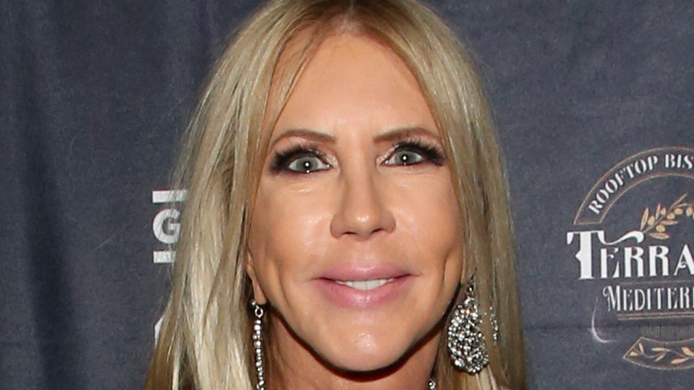 Vicki Gunvalson smiles with dangling earrings