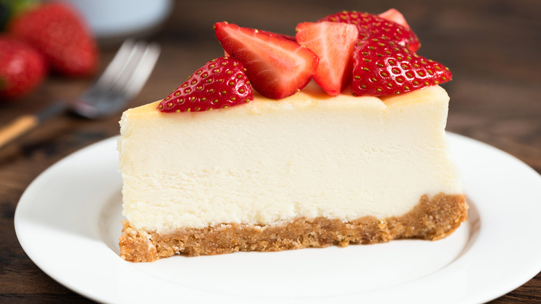 new york style cheesecake topped with strawberries on a plate