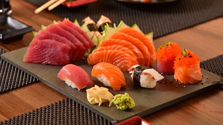 Various cuts of sushi on a wood plank