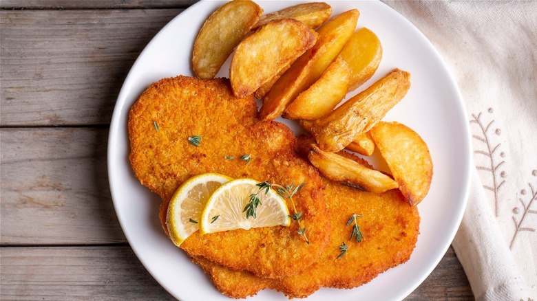 schnitzel and chips on plate