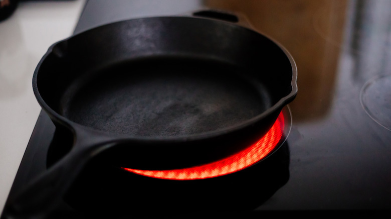 Cast-iron pan over glowing electric stove burner