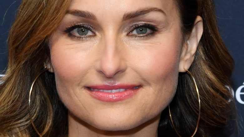 Giada De Laurentiis looking at camera with slight smile and hoop earrings