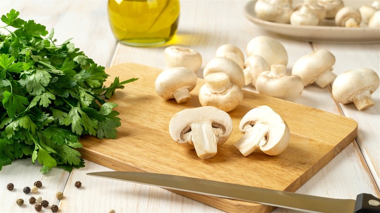 white mushrooms on wooden board
