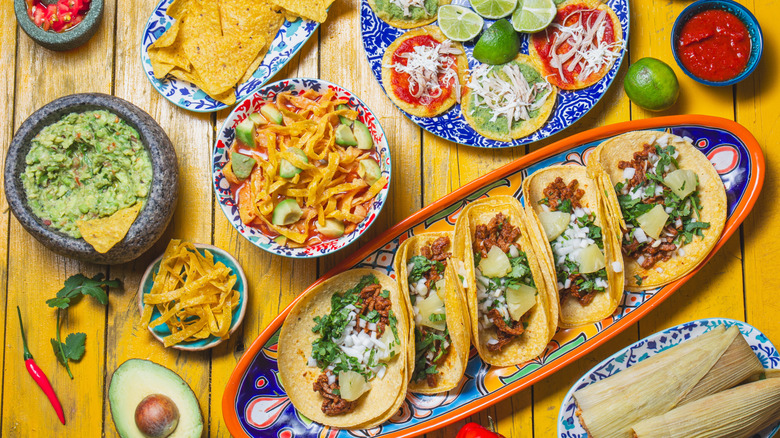 Tacos and dishes on table