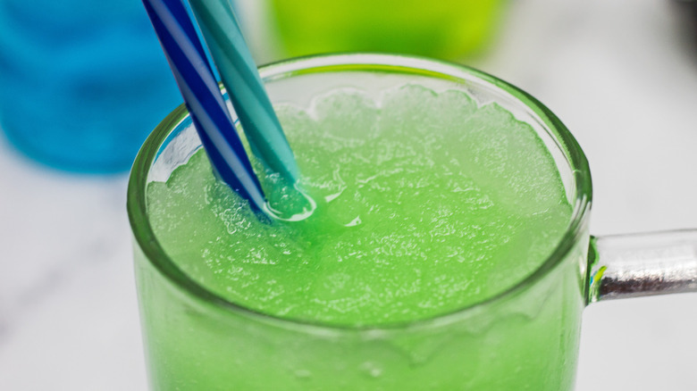 Green slushie with blue straw