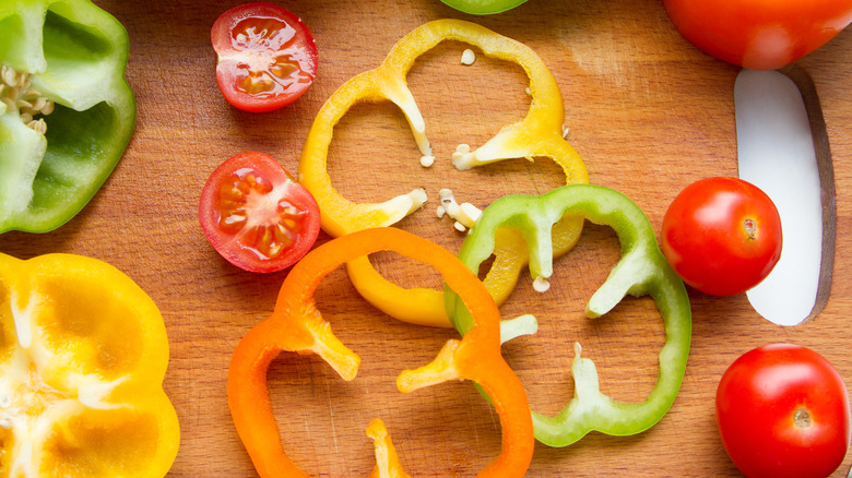 bell pepper rings on cutting board with tomatos