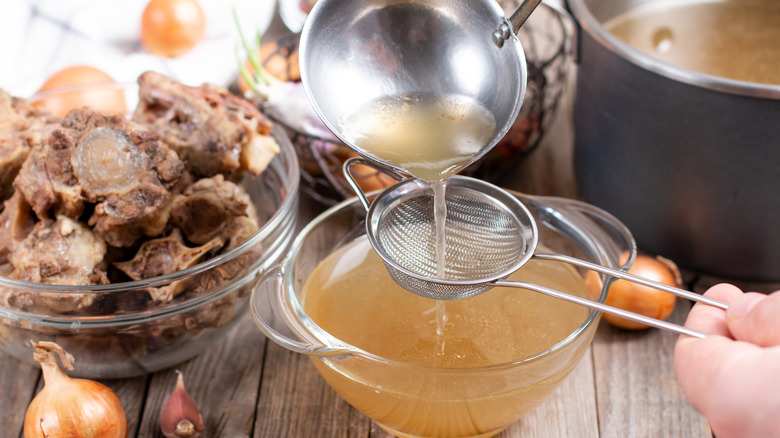 Bone broth being filtered 