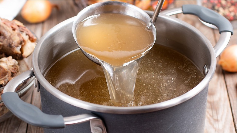 ladle in pot of broth